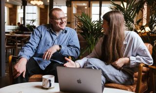 man and woman sat on a sofa