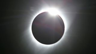 The sun is partially eclipsed in the first phase of a total eclipse in Grand Teton National Park on August 21, 2017