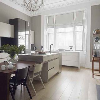 kitchen room with wooden flooring and dining table with flower jar