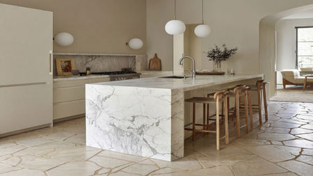 A sleek modern kitchen with tumbled edge limestone tiles
