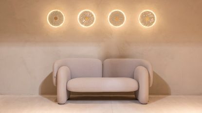 glass wall lamps above a cream sofa