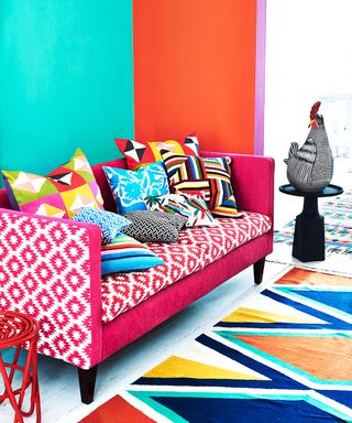 A vibrant, brightly colored living room with patterned sofa and cushions.