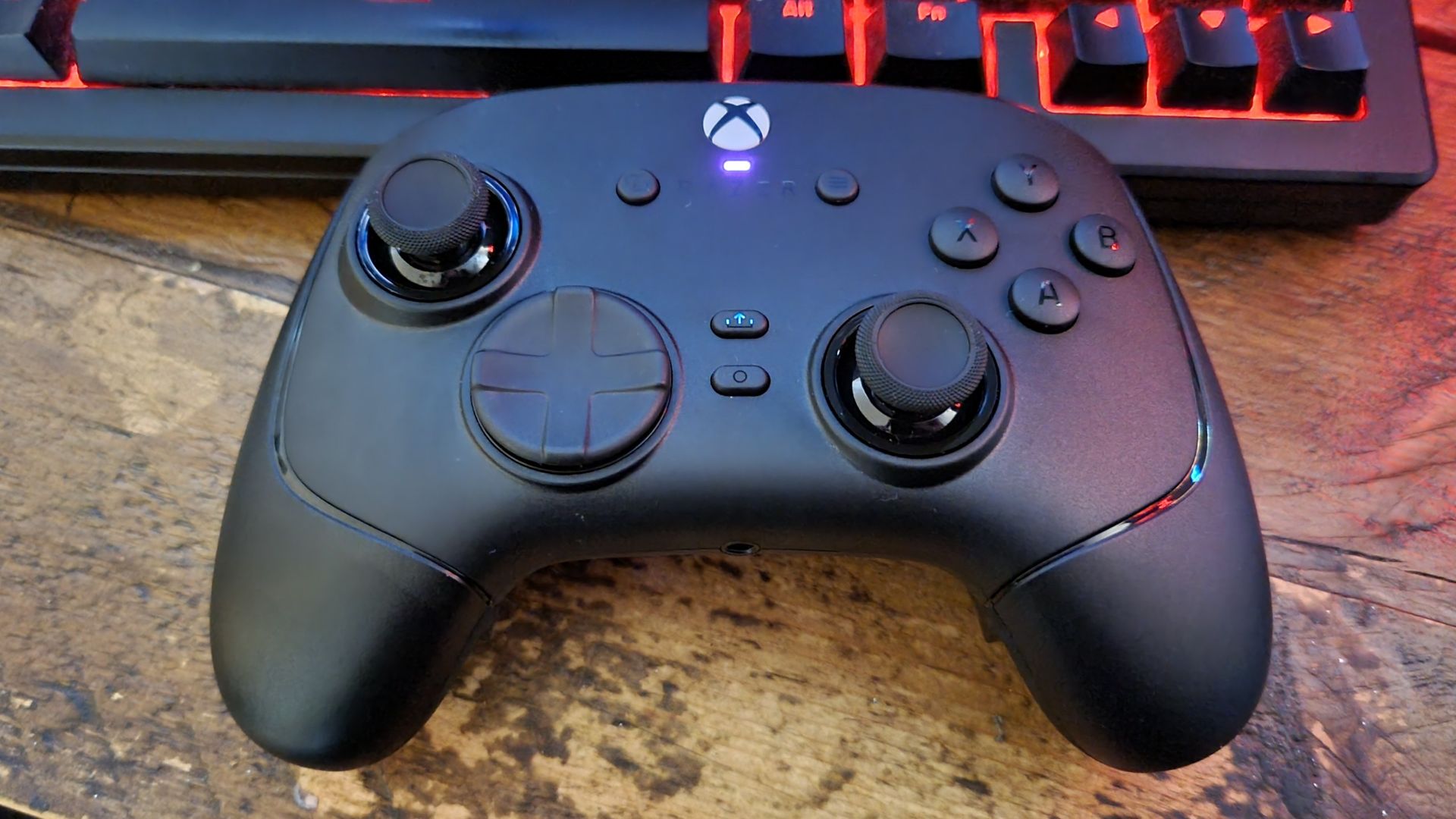 A Razer Wolverine V4 Pro gaming controller shot from above on a desk, below a gaming keyboard