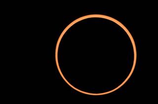a ring of orange light against a black background.