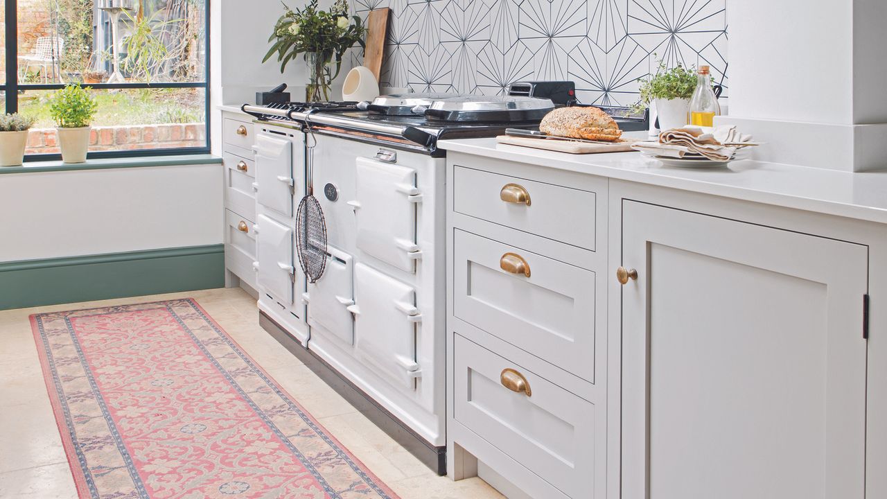 Light grey shaker kitchen with antique-inspired runner rug.