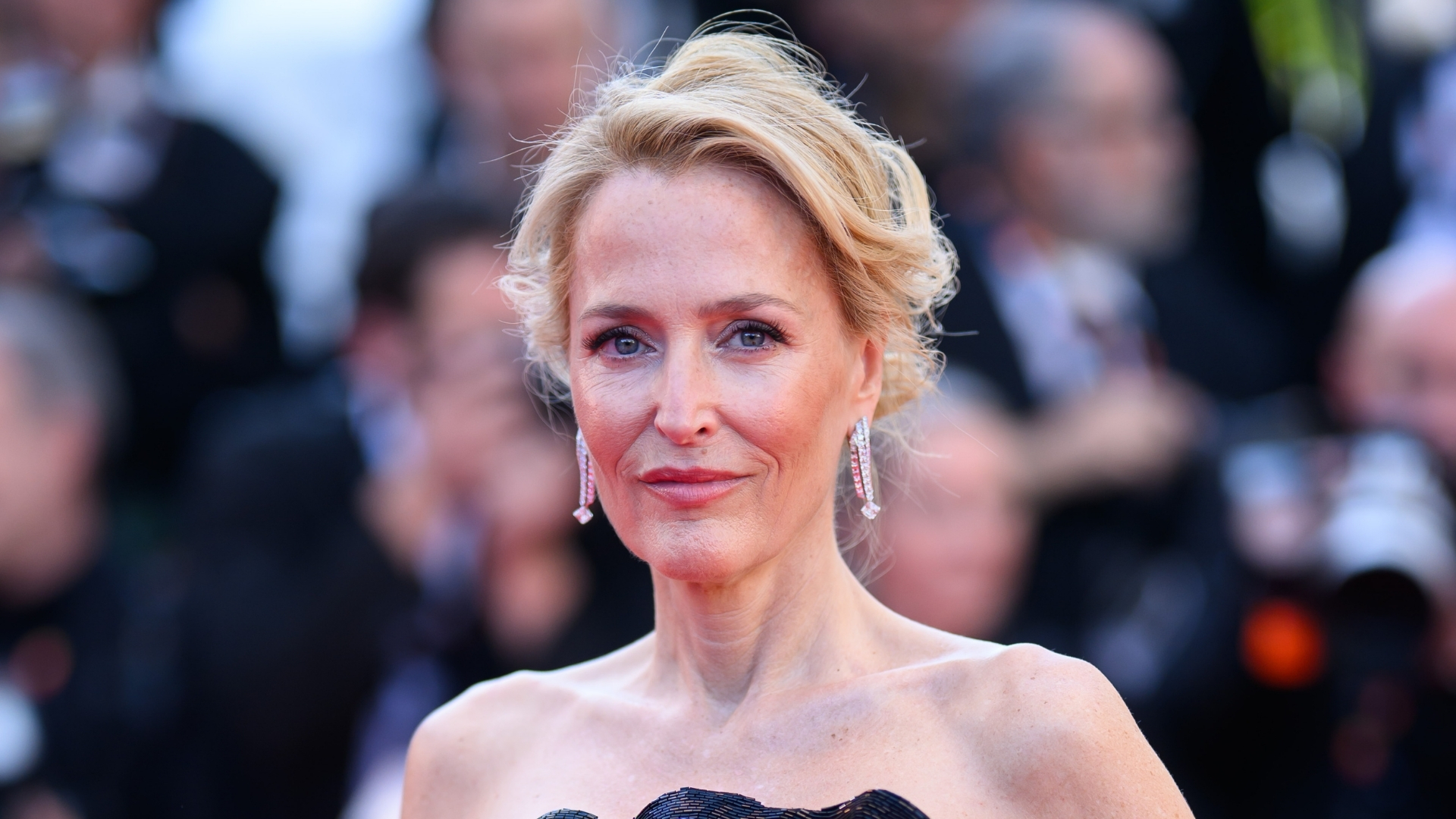 Gillian Anderson is pictured with her hair up and wearing a strapless dress at the "Histoires De La Nuit" (The Birthday Party) screening during the 79th annual Cannes Film Festival at Palais des Festivals on May 22, 2026, in Cannes, France. 