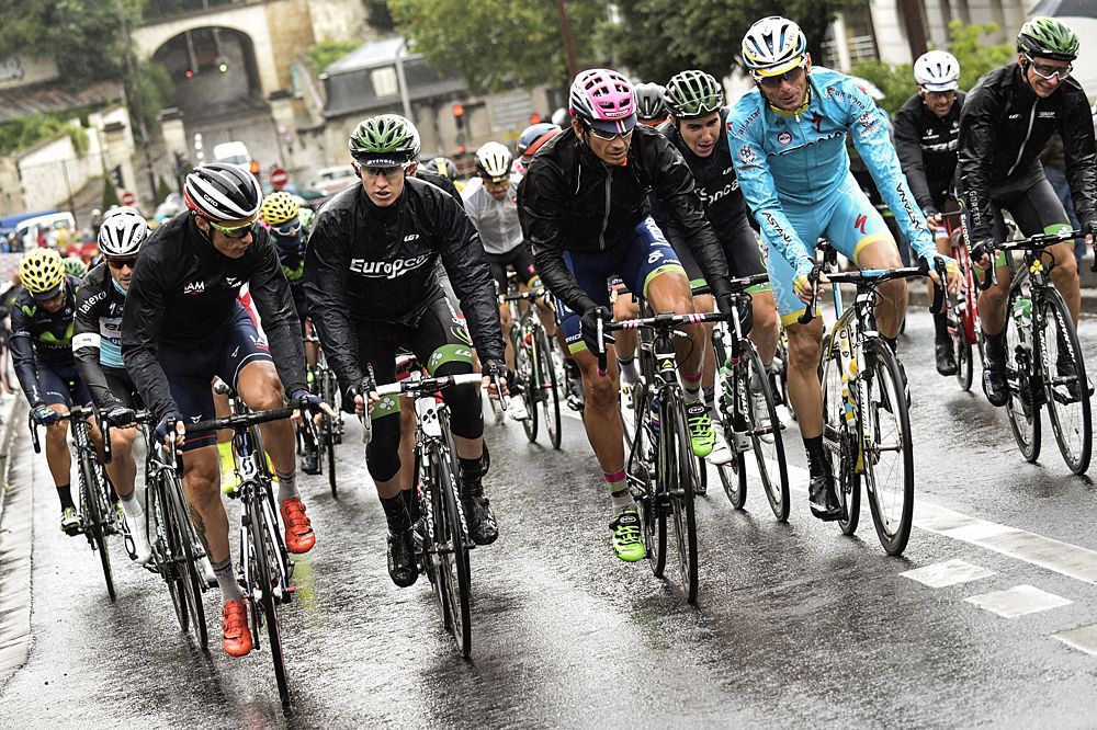 Riders are wearing rain jackets on a rain-soaked stage 21 at the Tour de France