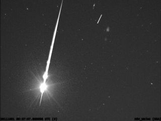 This image from a NASA meteor camera shows a stunning fireball light up jsut as a Russian rocket stage soars overhead (bright dot at upper right) on Sept. 30. 2011. A camera at NASA's Marshall Space Flight Center in Huntsville, Ala., recorded the view.