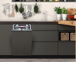 A matt charcoal grey kitchen with a NEFF N70 S586T60D0G, wood countertops, and