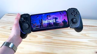 A phone running Fortnite with the Razer Kishi Ultra mobile controller
