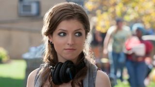 Anna Kendrick with headphones around neck in Pitch Perfect 