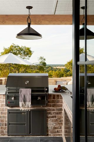 a grill in an outdoor kitchen