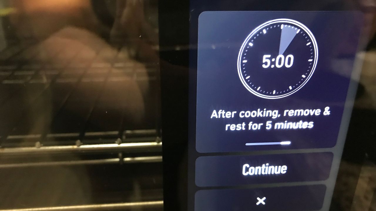 June Oven cooking burgers