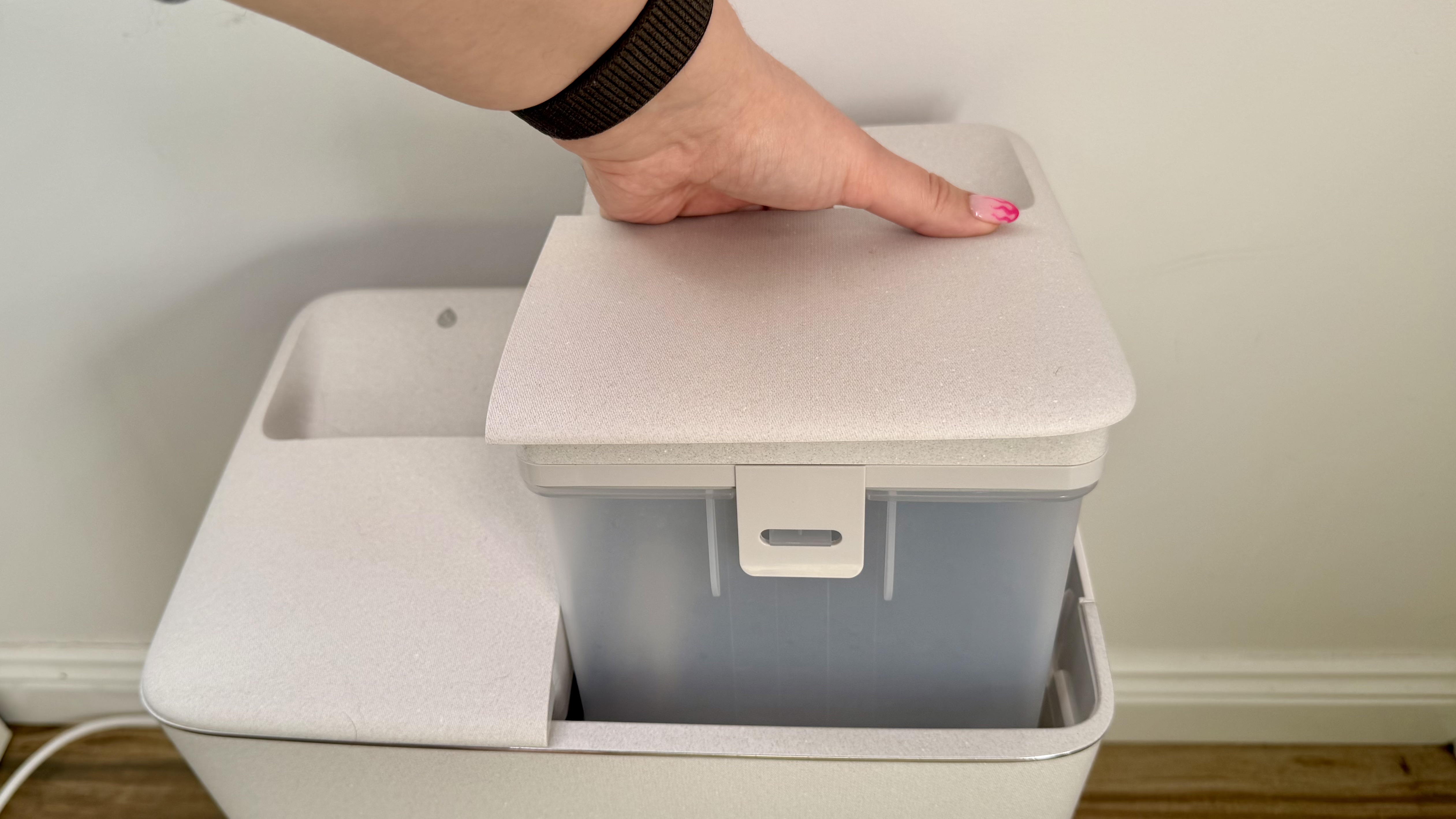 Hand holding Ecovacs clean water tank