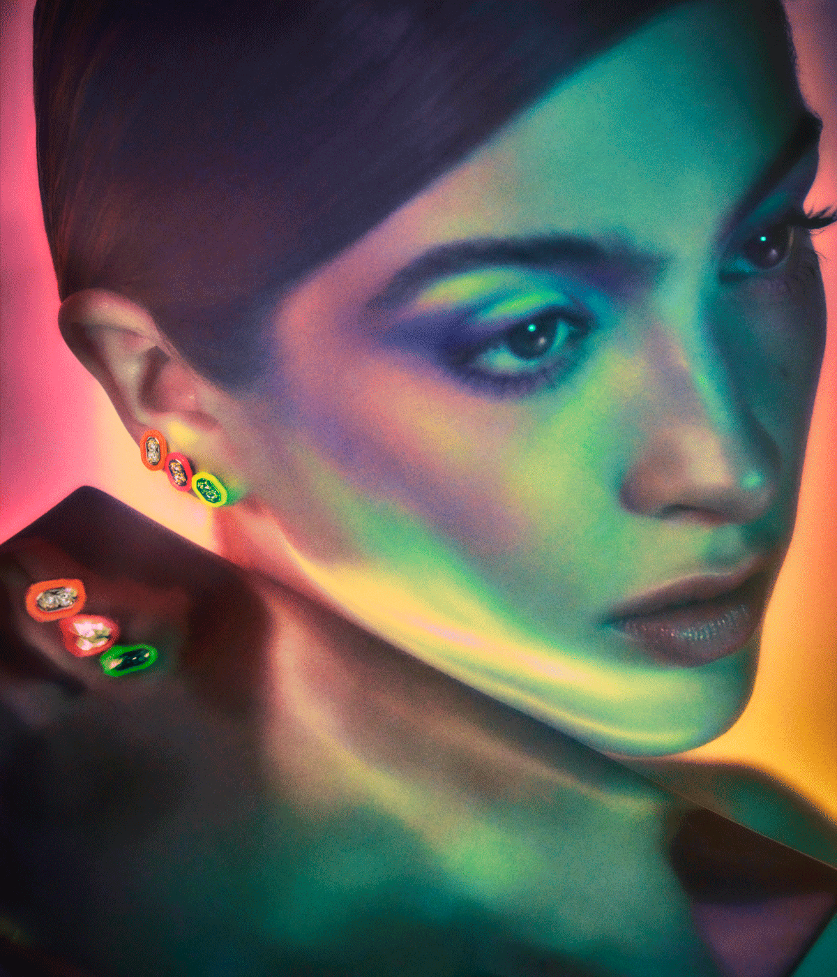 woman wearing neon and diamond earrings