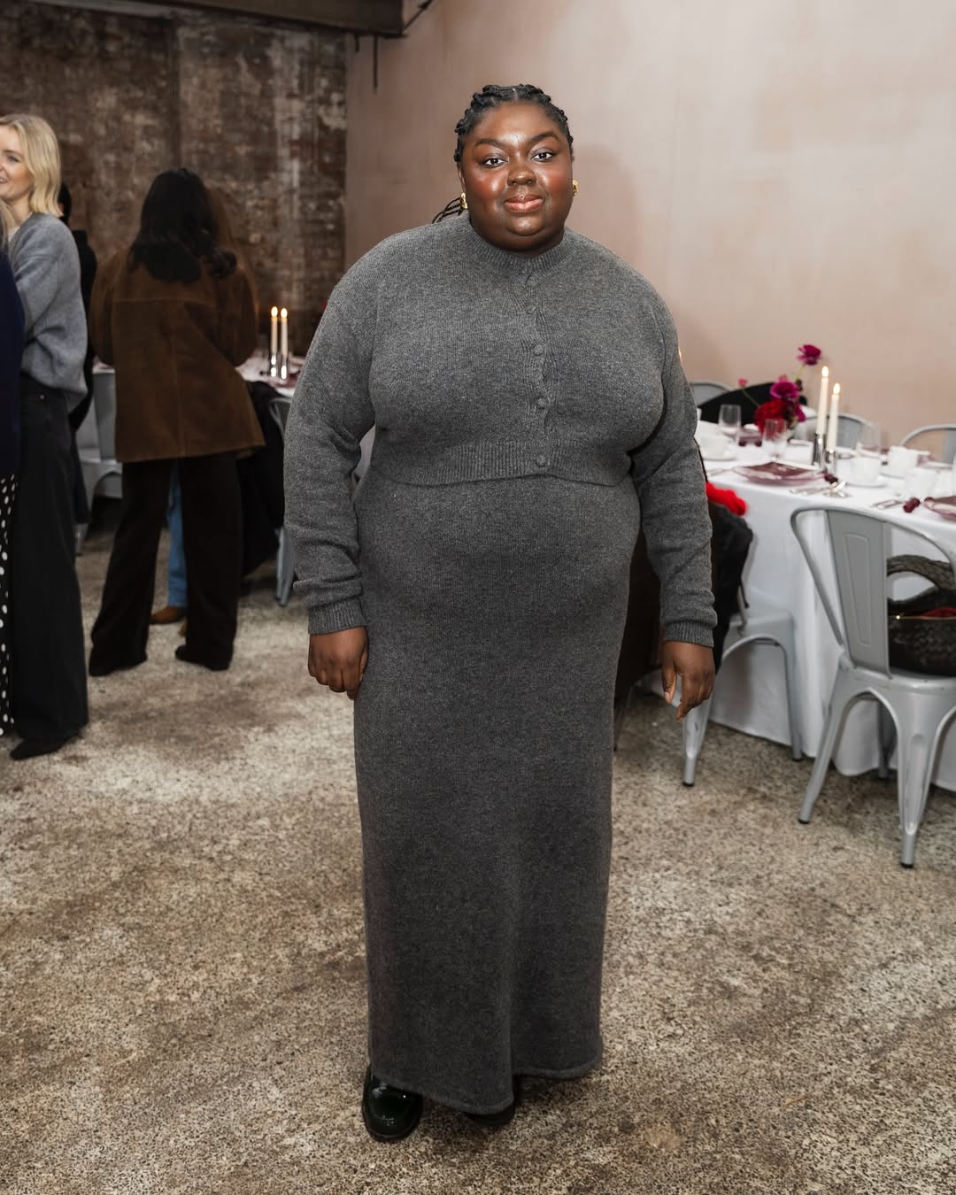 Abi Marvel wears grey knit dress and matching grey cardigan