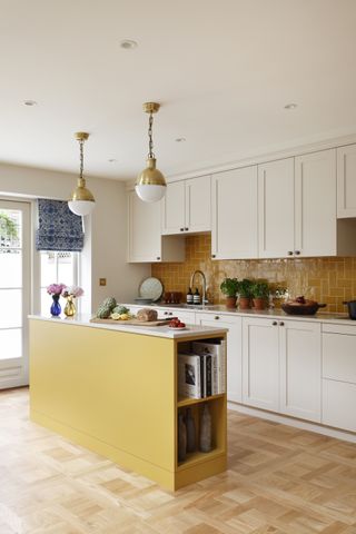 Kitchen with slim island in yellow