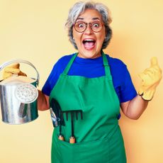 excited gardener with watering can and gardening tools