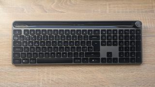 The JLab Epic Wireless Keyboard photographed on a wooden desk.