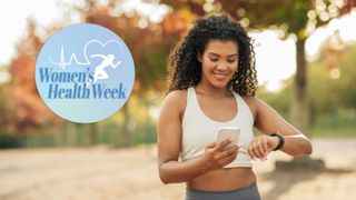 Woman with curly hair stood outside in nature looking at phone and fitness tracker smiling, Women's Health Week badge top left