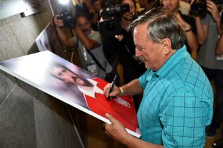 Czechoslovakia legend Antonin Panenka signs a portrait in October 2014.