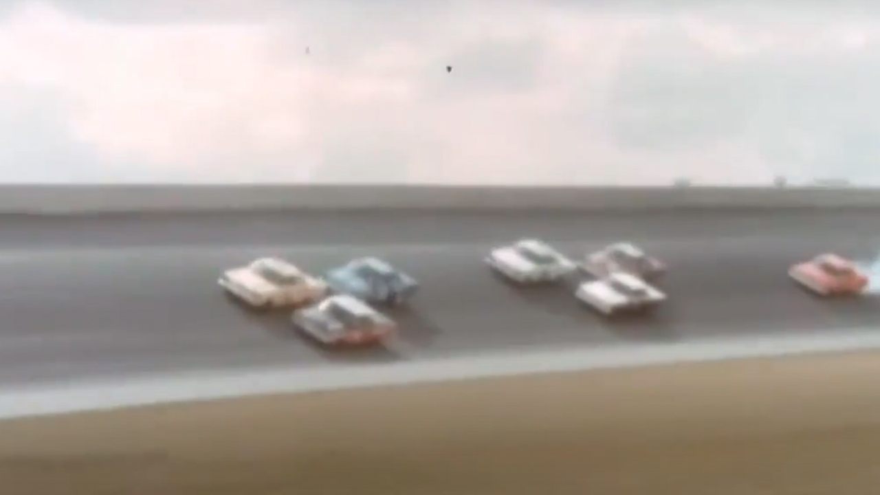 Cars racing around a track in Fireball 500