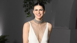 Alexandra Daddario at the Academy of Motion Pictures in iconic white dress.