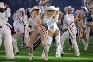 Beyonce performs with her backup dancers during her NFL christmas half time show