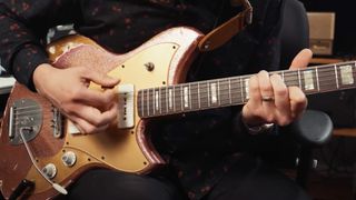 Guitarist Rhett Shull plays a chord inversion