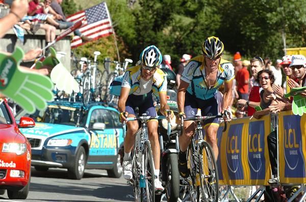 Armstrong and Kloden as the US flag flys in the background