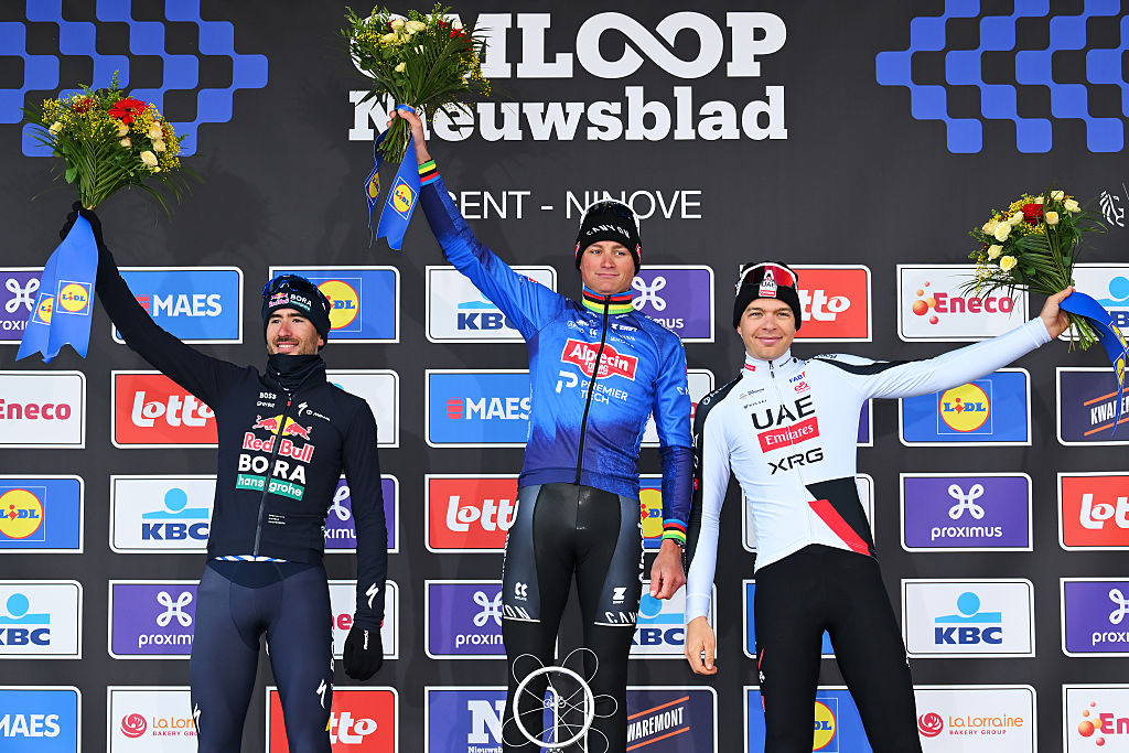 NIVONE, BELGIUM - FEBRUARY 28: (L-R) Tim van Dijke of Netherlands and Team Red Bull - BORA - hansgrohe on second place, race winner Mathieu van der Poel of Netherlands and Team Alpecin-Premier Tech and Florian Vermeersch of Belgium and UAE Team Emirates - XRG on third place pose on the podium ceremony after the 21st Omloop Het Nieuwsblad 2026, Men&amp;amp;apos;s Elite a 207.2km one day race from Ghent to Ninove / #UCIWT / on February 28, 2026 in Ninove, Belgium. (Photo by Tim de Waele/Getty Images)