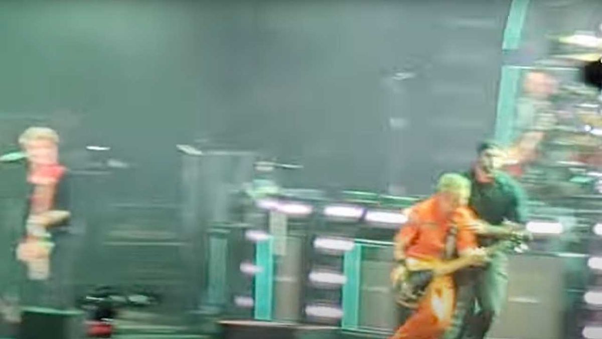 Green Day being ushered offstage