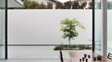 A dining room leading out onto a backyard garden space