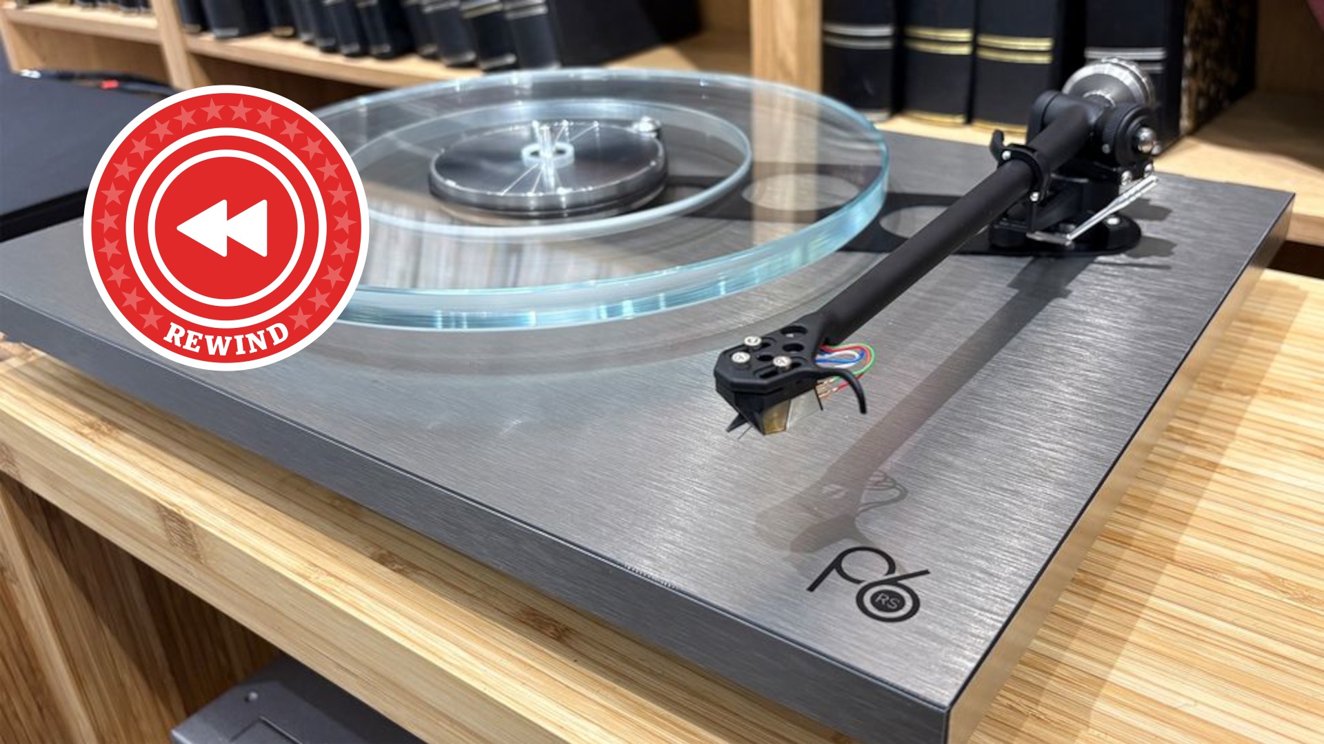 Rega turntable on desk with Rewind logo