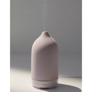 lilac matte stoneware essential oil diffuser in a tall curved shape