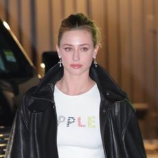 Lili Reinhart Embodies Y2K Dressing in a Black Bomber Jacket, Pleated Mini Skirt, and Edgy Black Boots