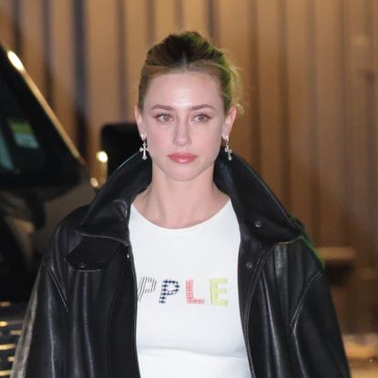 Lili Reinhart Embodies Y2K Dressing in a Black Bomber Jacket, Pleated Mini Skirt, and Edgy Black Boots
