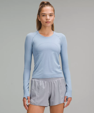 Female model wearing pale blue long-sleeve shirt