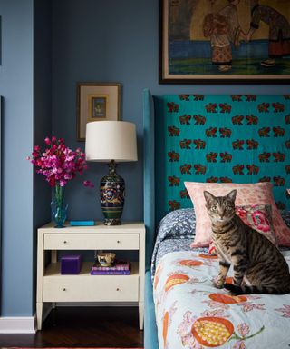 Small blue bedroom with pattern headboard