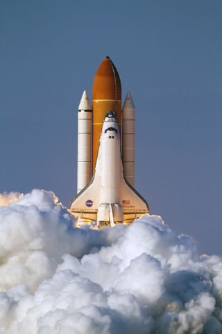 As if soaring through the heavens, space shuttle Discovery launches through rolling clouds of smoke and steam, embarking on its final scheduled mission, STS-133, to the International Space Station. Liftoff from launch Pad 39A at NASA's Kennedy Space Cente