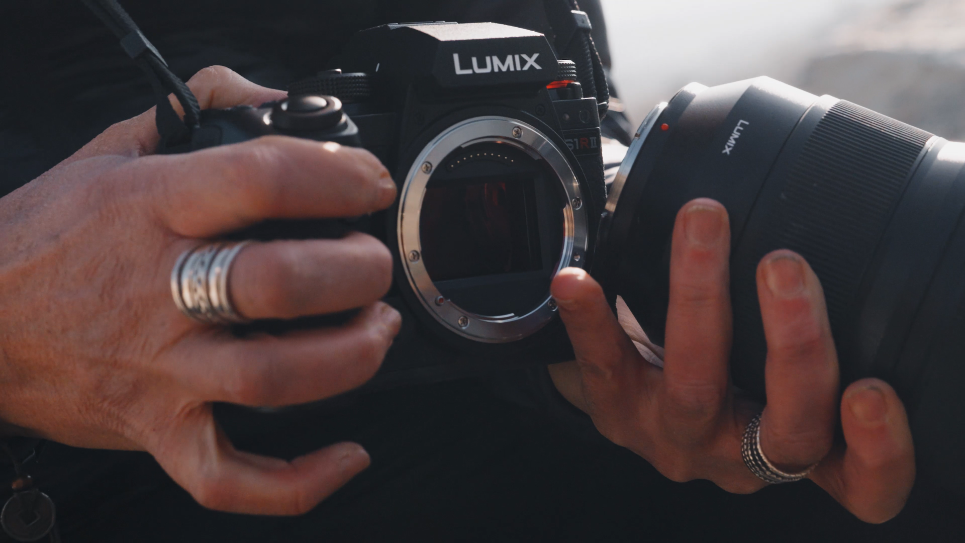 Closeup of a photographer holding a LUMIX S1RII camera
