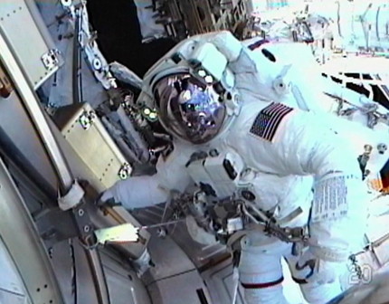 Mission Specialist Drew Feustel works outside the International Space Station, as seen in this view from the helmet camera of Mission Specialist Greg Chamitoff while they conduct the first spacewalk of the STS-134 mission on May 20, 2011 (Flight Day 5).