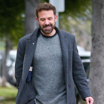 Ben Affleck wearing a gray shirt and gray coat while walking in Los Angeles.