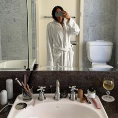 Camelia Farhoodi taking a bathroom mirror selfie.