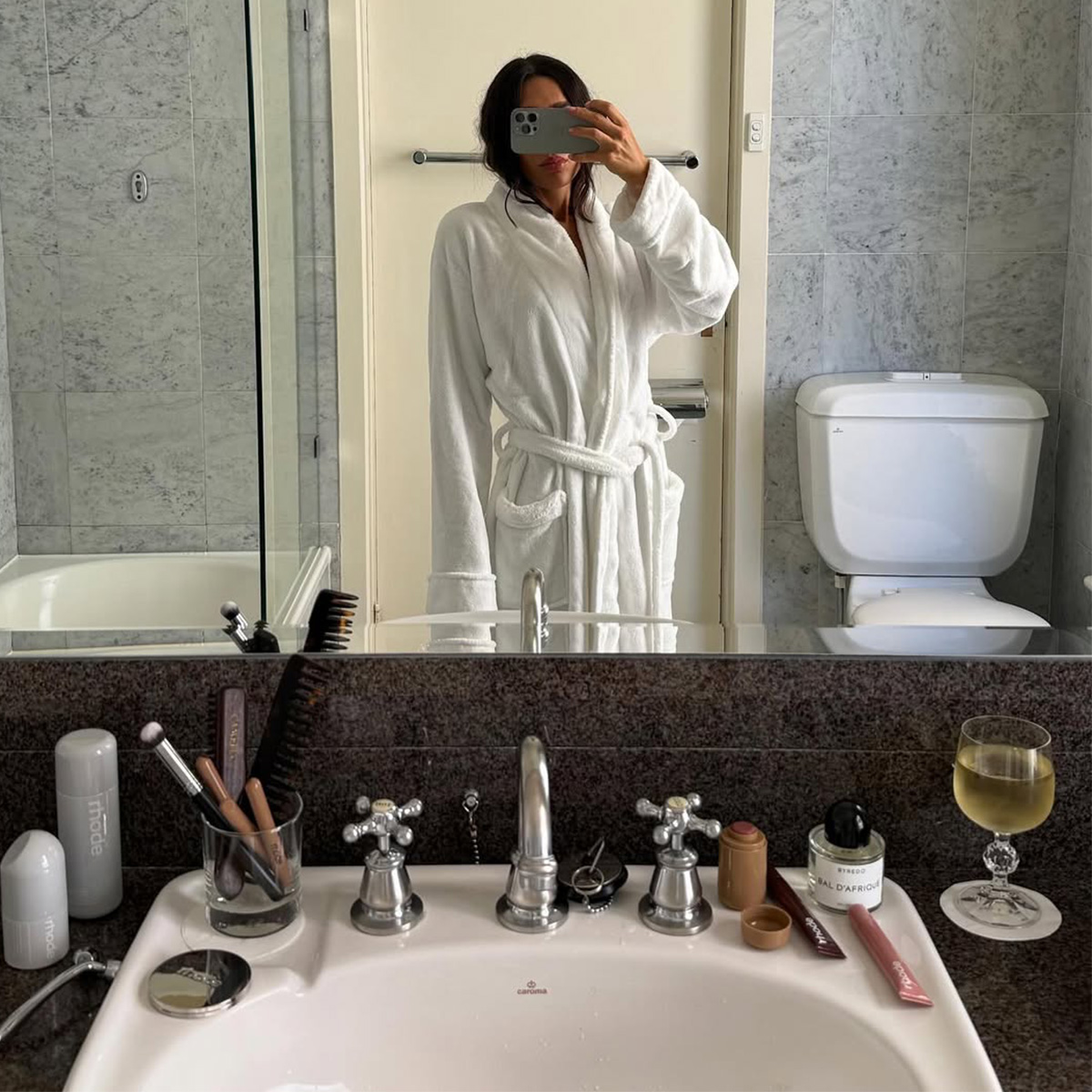 Camelia Farhoodi taking a bathroom mirror selfie. 