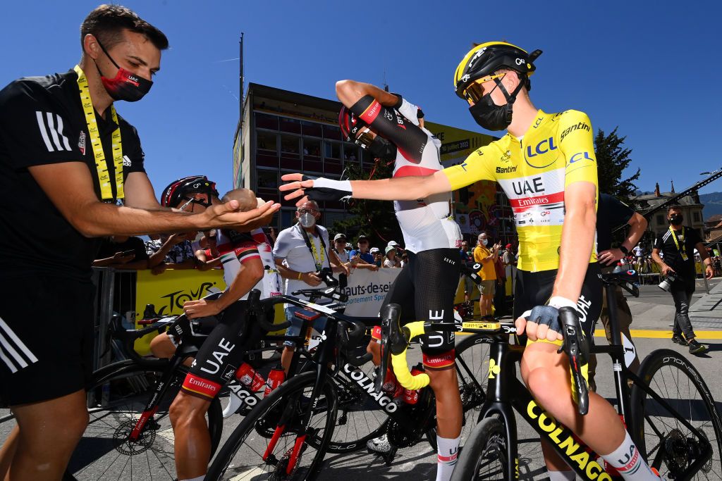 Tadej Pogacar takes on some ice before the Tour de France stage start