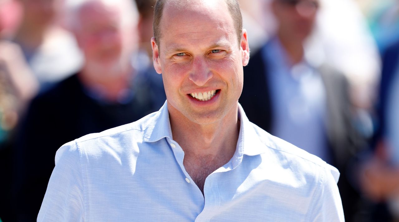 Prince William wears a light blue shirt with the top buttons undone