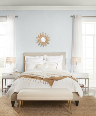 A light gray bedroom with a white bed.
