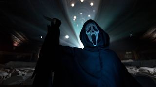 Ghostface running through a cinema holding a knife during Scream 6.