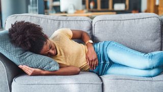 woman with ibs on her sofa